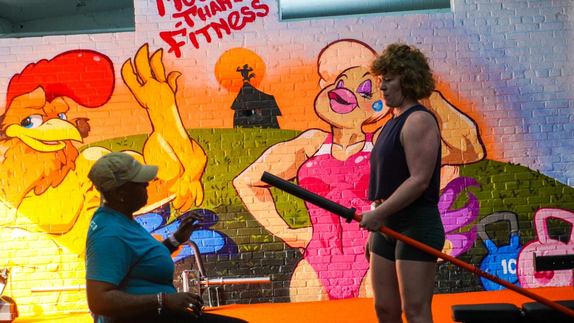 Personal Trainer helping client with an exercise